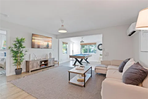 a living room with furniture a window and a fireplace
