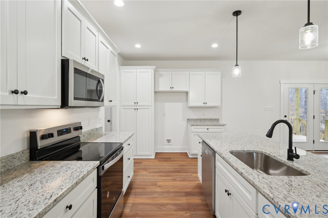 2090 Cartersville Road Cartersville, VA 23027 - Photo 11 of 35 a kitchen with stainless steel appliances granite countertop a sink stove and refrigerator