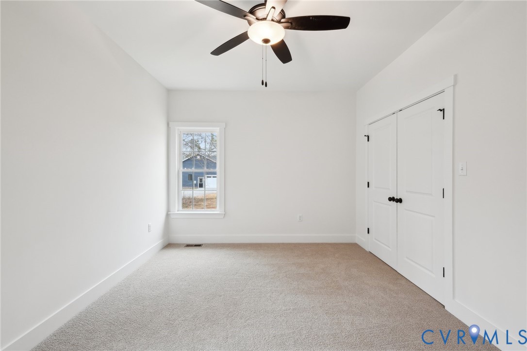 2090 Cartersville Road Cartersville, VA 23027 - Photo 27 of 35 an empty room with ceiling fan and window