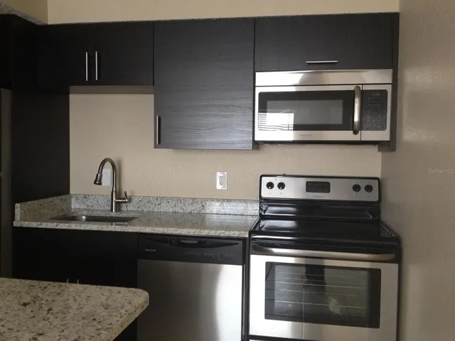 a kitchen with a stove and a microwave