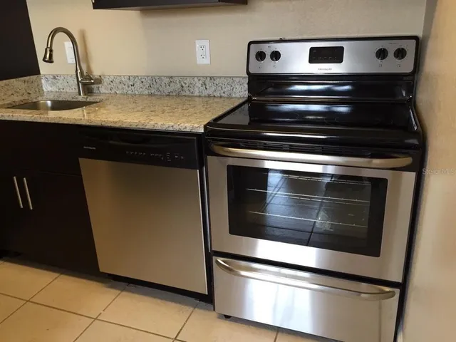 a stove top oven sitting inside of a kitchen