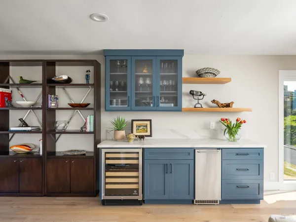 a dining room with furniture large windows and a rug