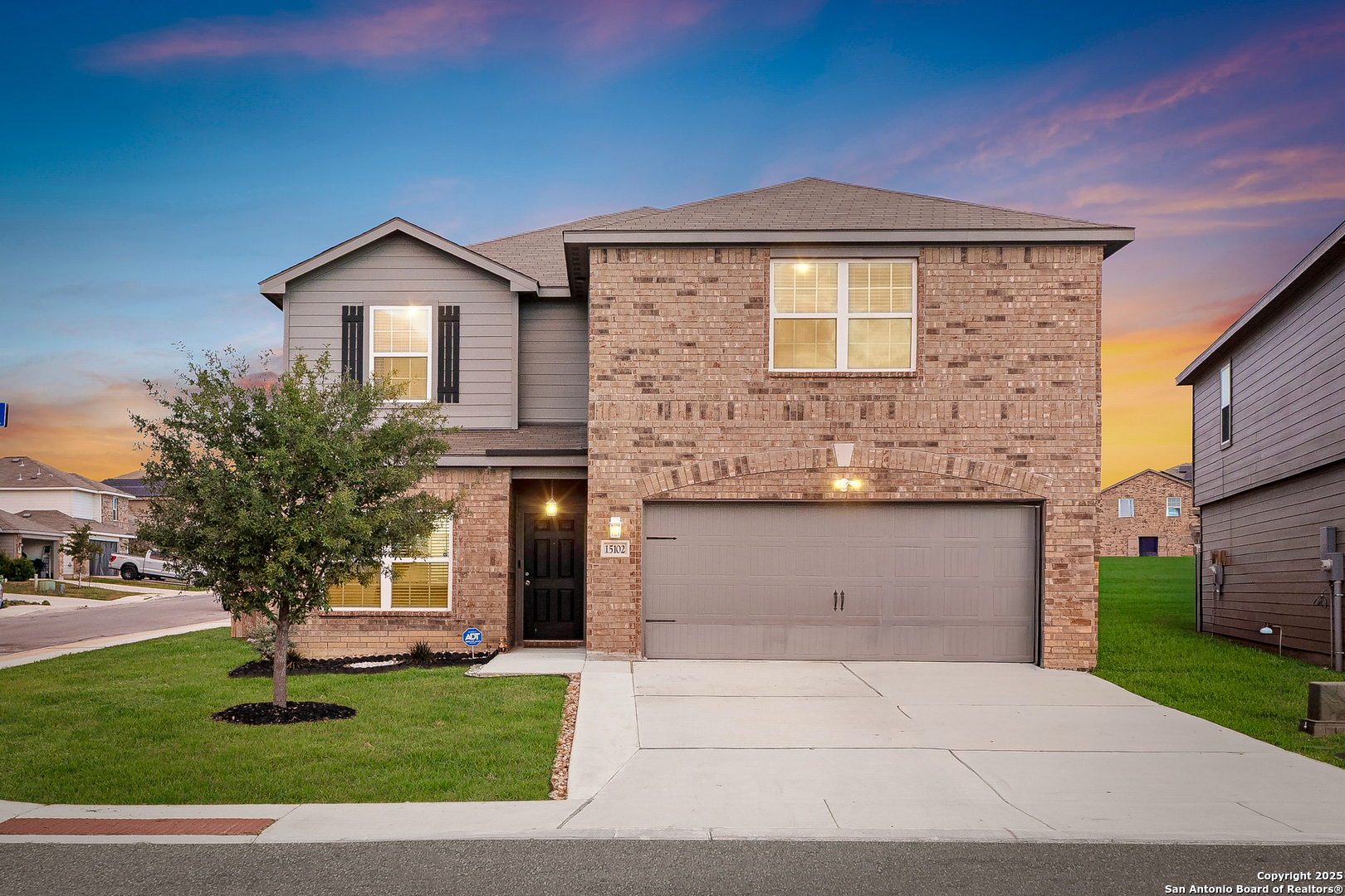 a front view of a house with a yard and garage