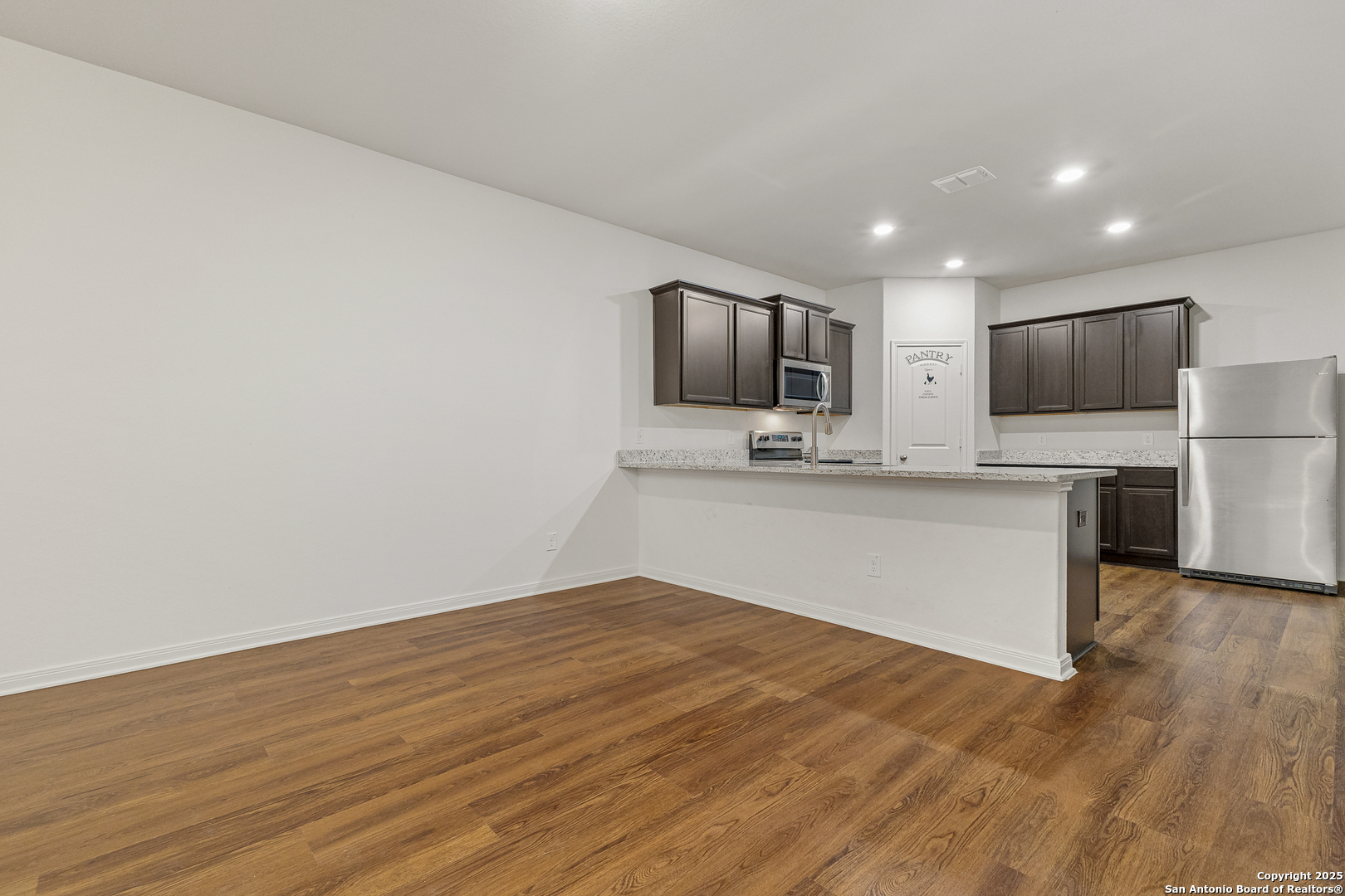 15102 Jetfire Von Ormy, TX 78073 - Photo 12 of 37 a large kitchen with a large counter top stainless steel appliances and cabinets