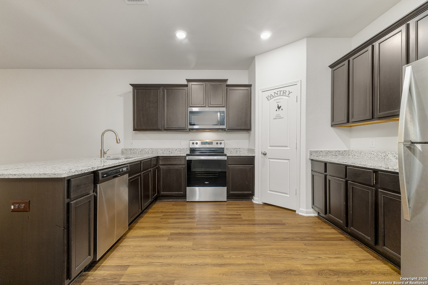 15102 Jetfire Von Ormy, TX 78073 - Photo 15 of 37 a kitchen with stainless steel appliances granite countertop a stove a sink and a refrigerator