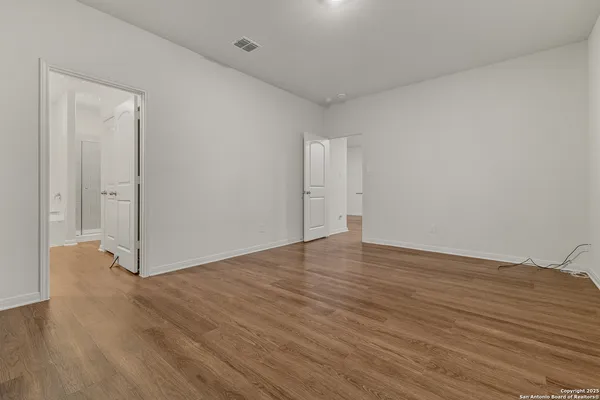 a view of an empty room and wooden floor