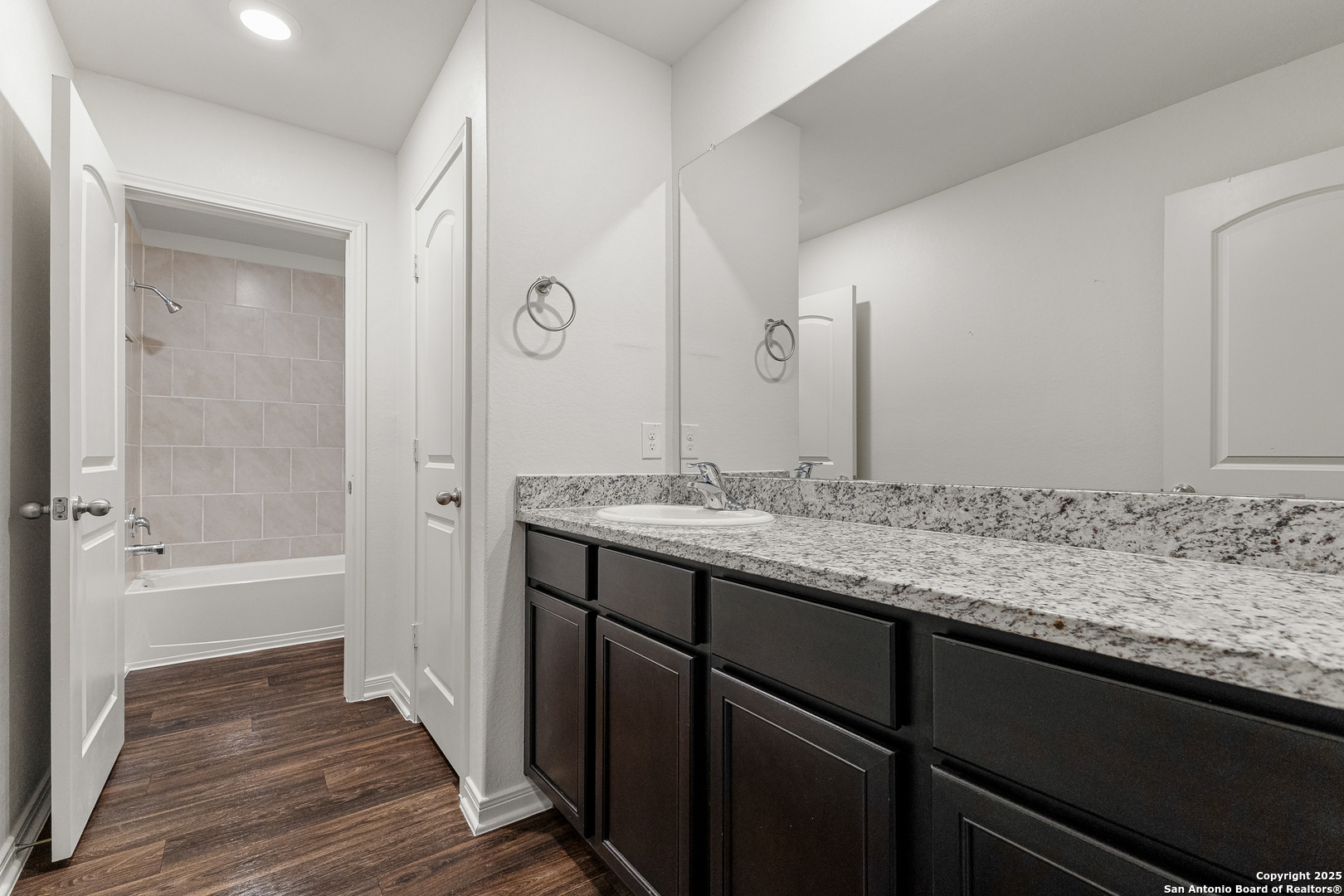 15102 Jetfire Von Ormy, TX 78073 - Photo 27 of 37 a bathroom with a granite countertop sink and a mirror