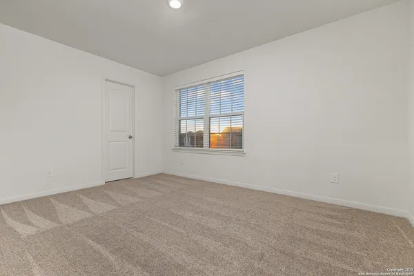 a view of a chairs and table in the back yard of a building