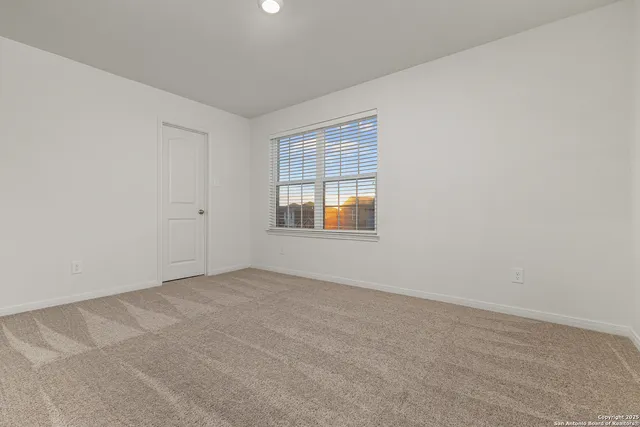 a view of a chairs and table in the back yard of a building