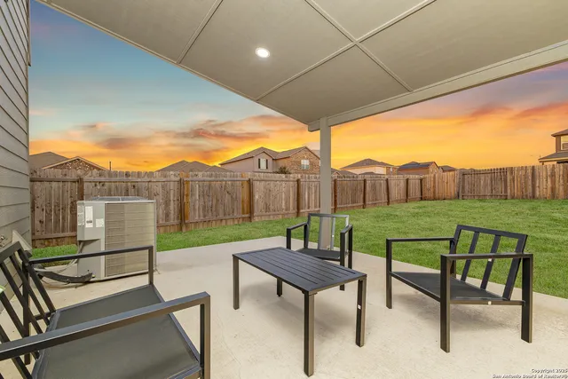 a view of a patio with a backyard