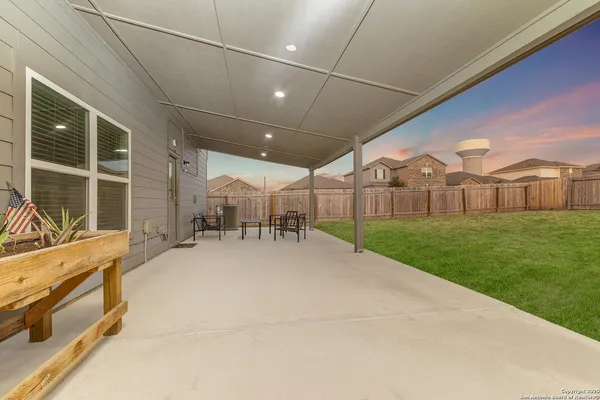 a view of a house with a yard and sitting area