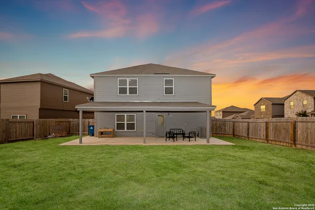 a view of a house with a yard and sitting area