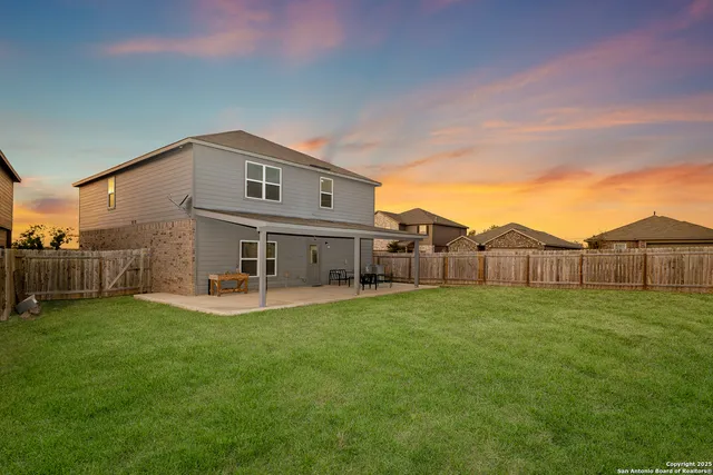 a view of a house with a yard and sitting area