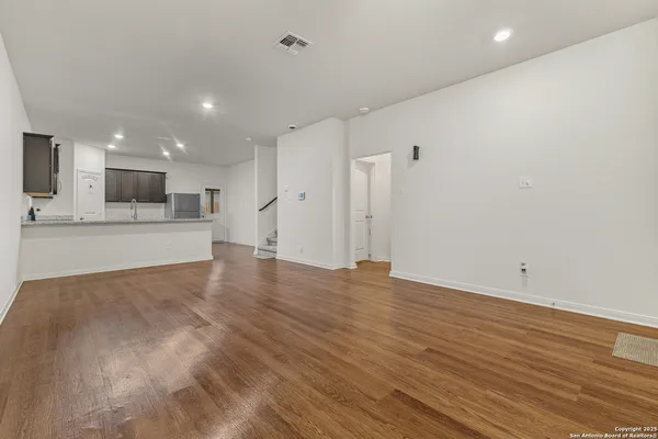 a view of a kitchen with a sink and a refrigerator