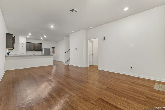 a view of a kitchen with a sink and a refrigerator