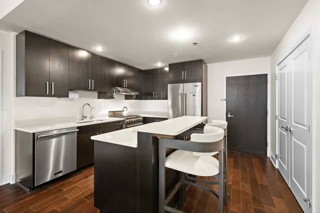 a kitchen with a sink cabinets and wooden floor