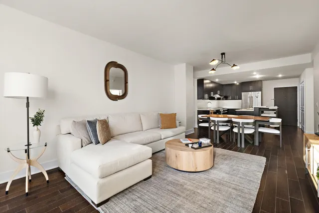 a living room with furniture and kitchen view