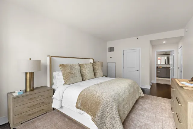 a bedroom with a bed and a view of kitchen