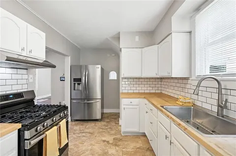 a kitchen with a sink stove and refrigerator