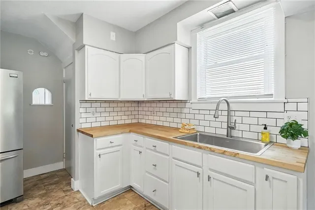 a kitchen with a sink and cabinets
