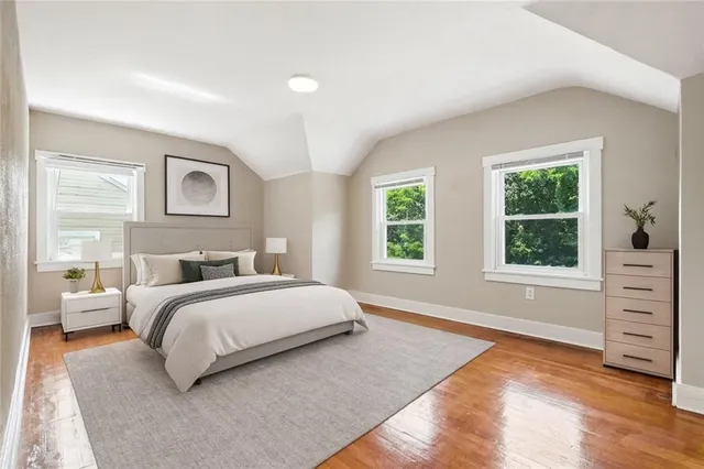 a spacious bedroom with a bed and a window