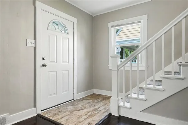 a view of entryway and hall with wooden floor