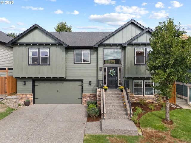 a front view of a house with a yard and garage