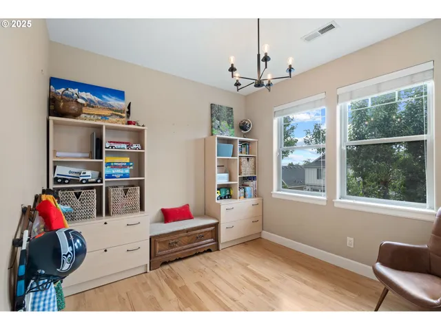 a living room with furniture cabinets and window