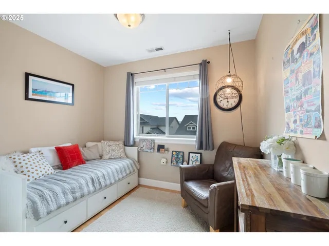 a living room with furniture and a book shelf