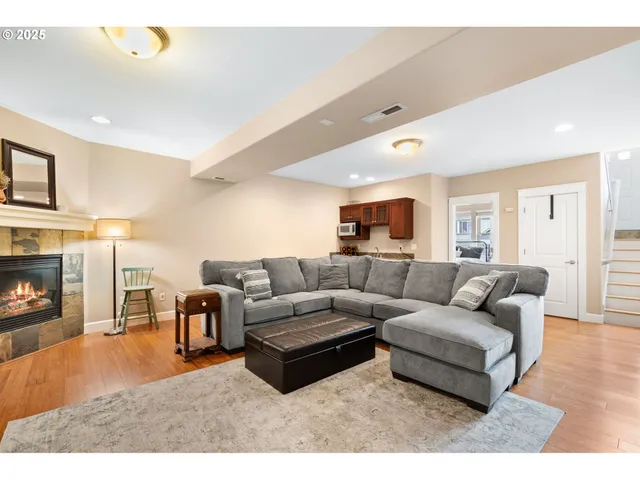 a bedroom with a bed a painting and a window