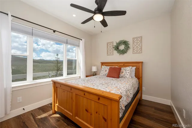 a bedroom with a large bed and a large window