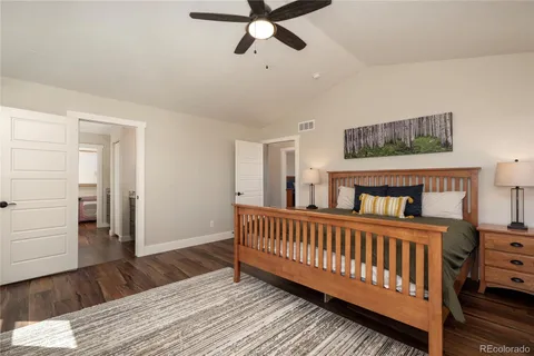 a view of a bedroom with furniture and wooden floor