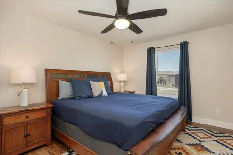 a bedroom with a large bed and a chandelier