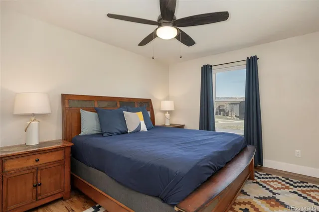a bedroom with a large bed and a chandelier