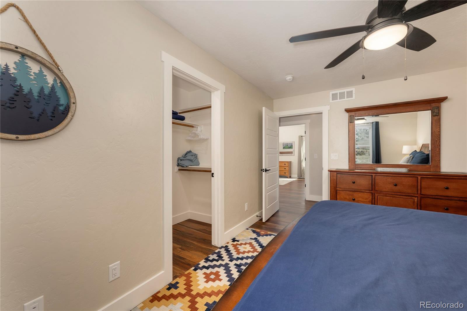 719 Saddle Ridge Circle Granby, CO 80446 - Photo 25 of 47 a bedroom with a bed and a large mirror on the dresser