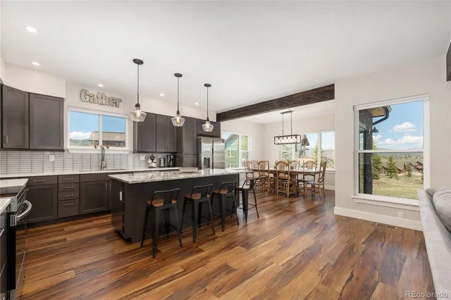 a large kitchen with lots of counter space and dining table