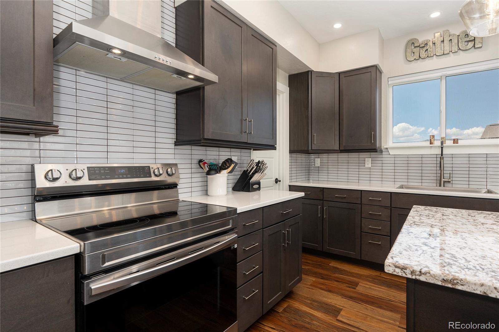 719 Saddle Ridge Circle Granby, CO 80446 - Photo 4 of 47 a kitchen with wooden cabinets and stainless steel appliances