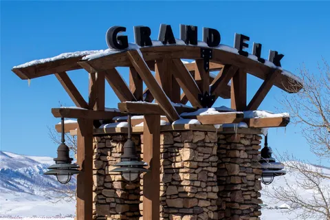 a view of a wooden chairs and table in a patio