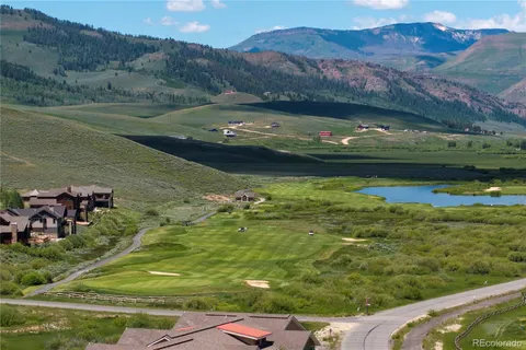an aerial view of a house with a yard lake view and mountain view