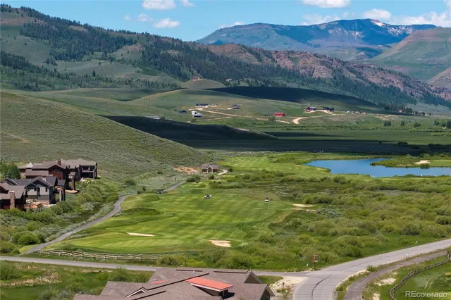 an aerial view of a house with a yard lake view and mountain view