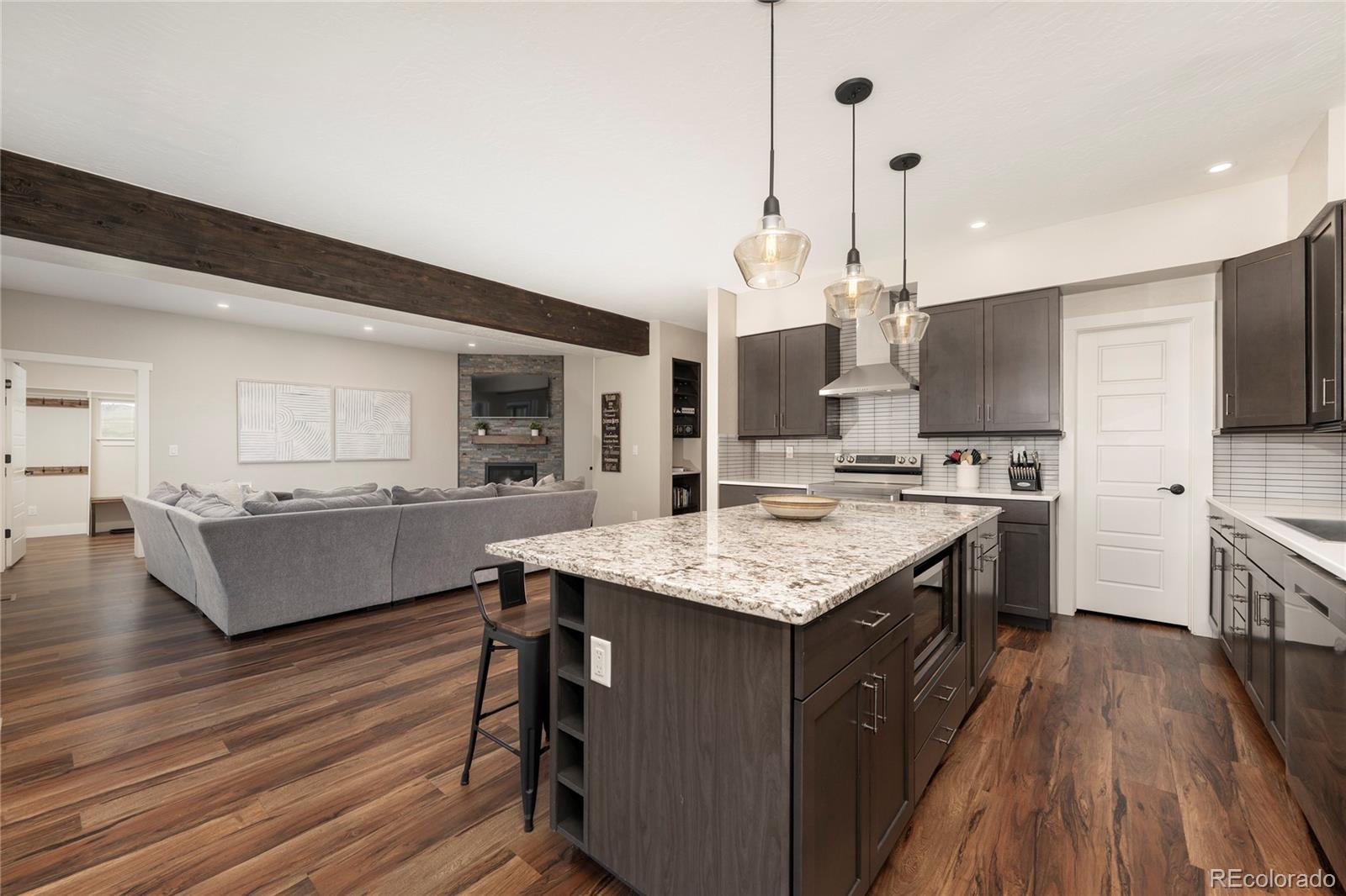 719 Saddle Ridge Circle Granby, CO 80446 - Photo 6 of 47 a kitchen with kitchen island a counter top space a sink stainless steel appliances and cabinets
