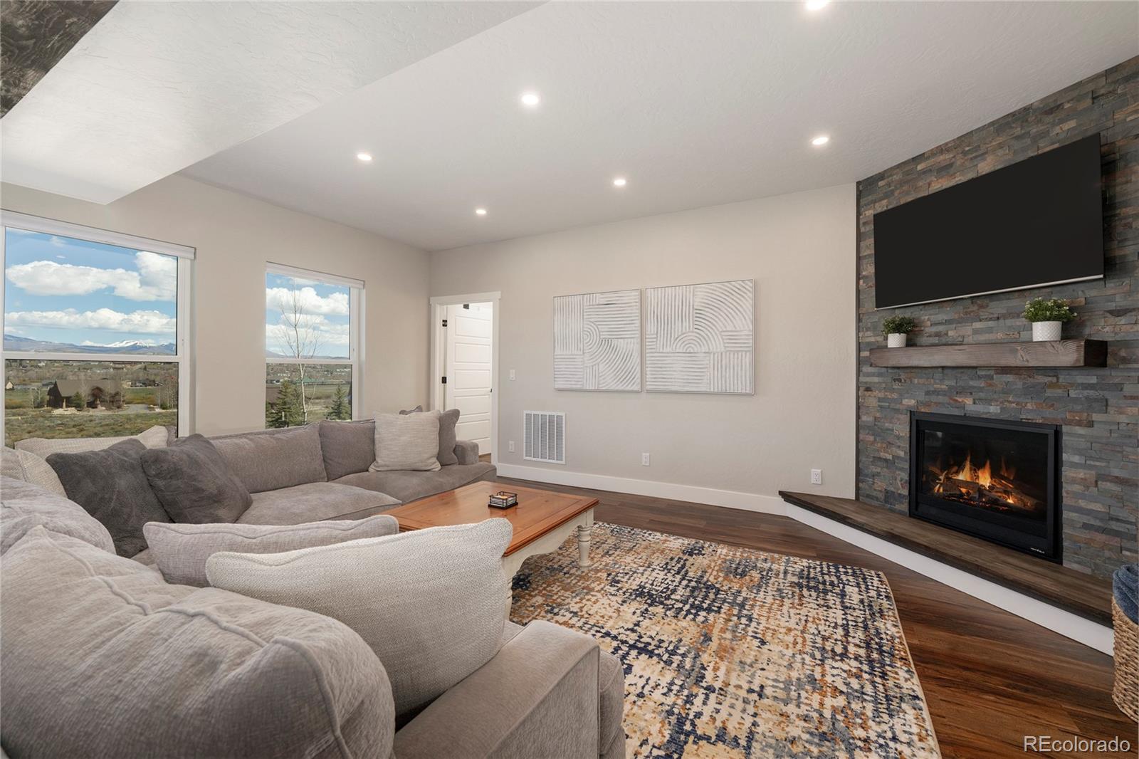 719 Saddle Ridge Circle Granby, CO 80446 - Photo 9 of 47 a living room with furniture flat screen tv and a fireplace