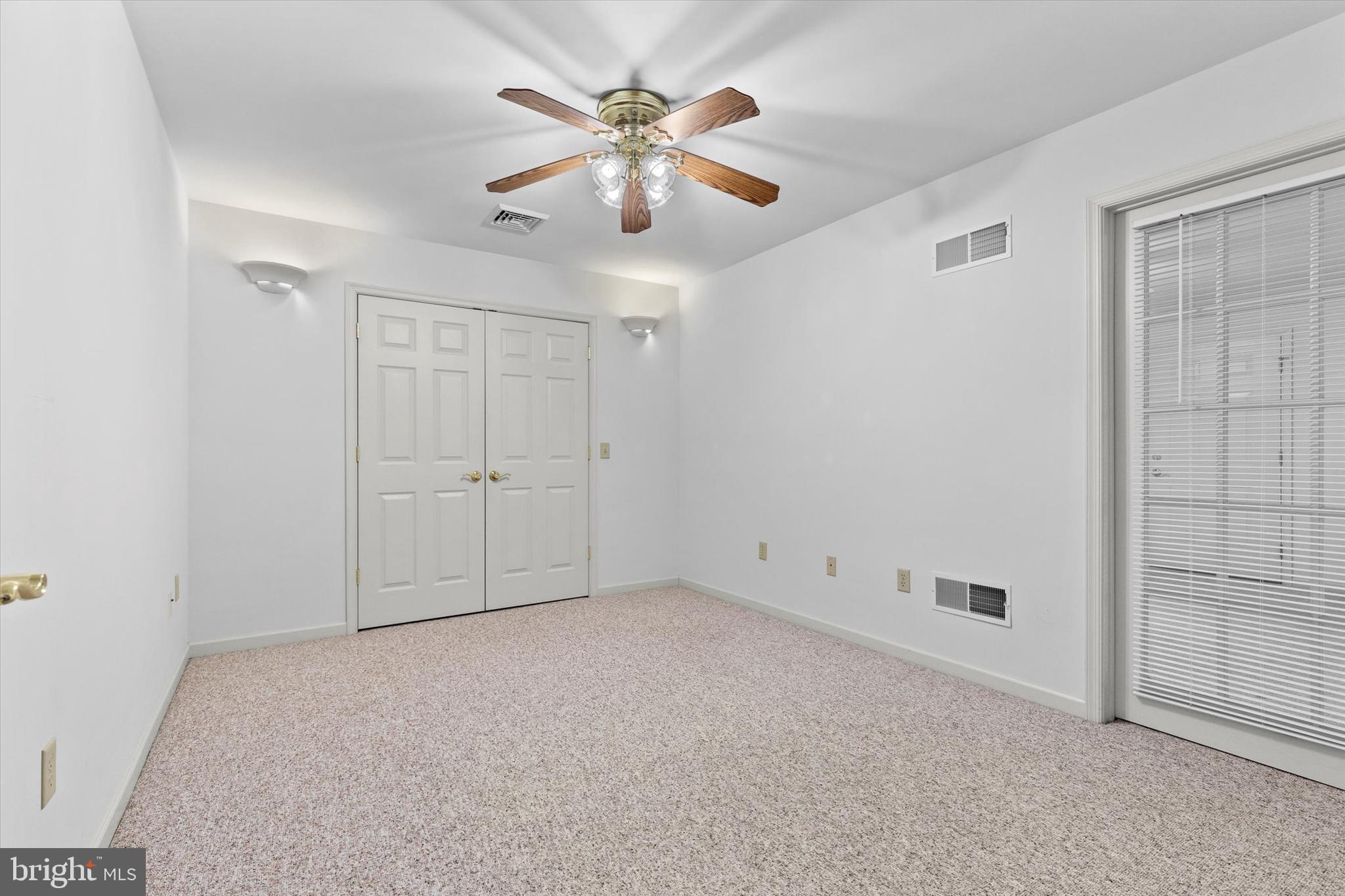 218 Equine Cove Red Lion, PA 17356 - Photo 12 of 24 an empty room with chandelier fan and windows