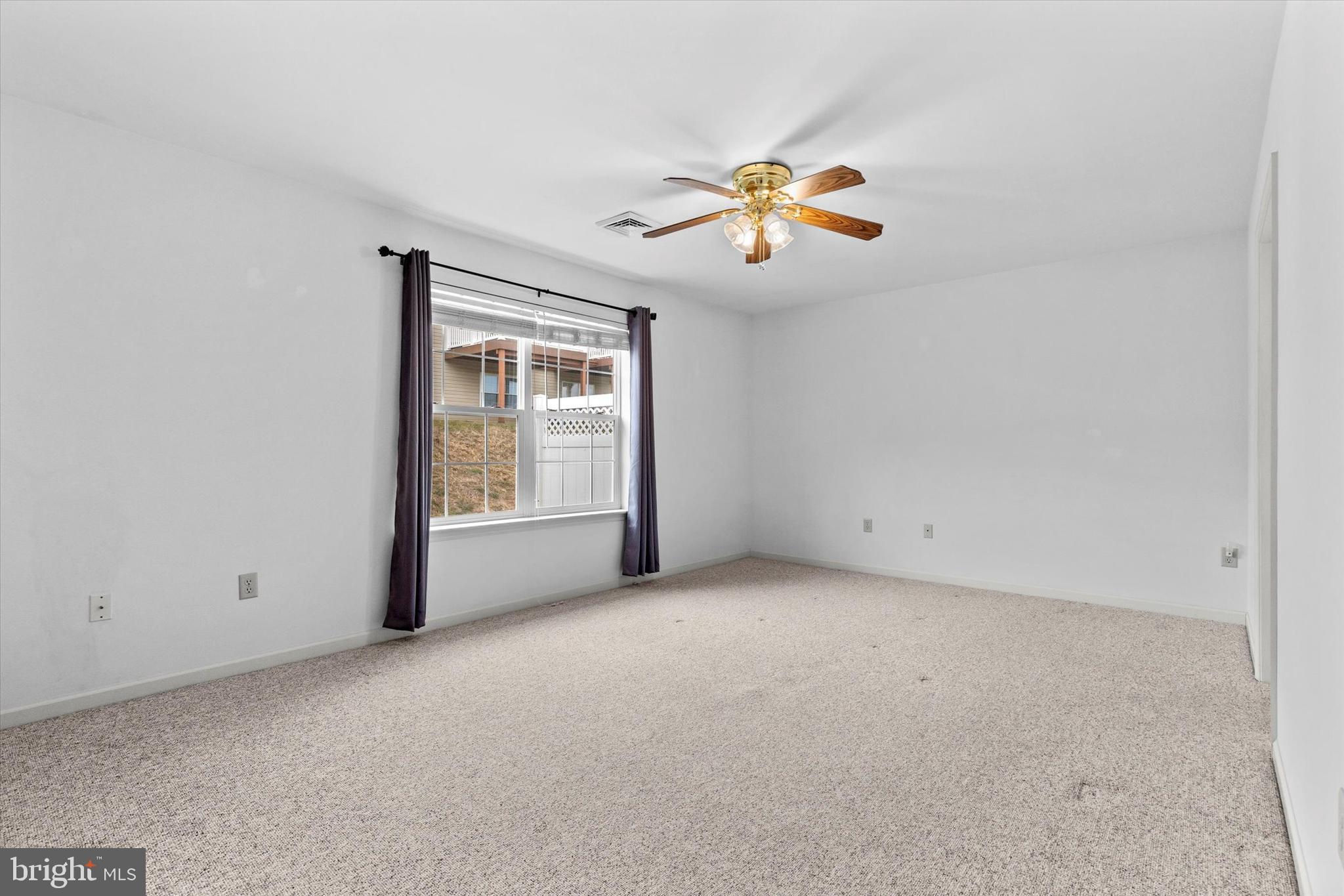 218 Equine Cove Red Lion, PA 17356 - Photo 16 of 24 an empty room with windows and chandelier fan