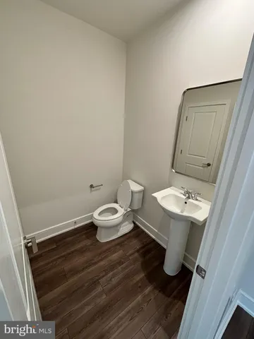 a bathroom with a sink a toilet and mirror