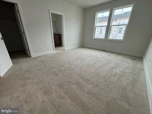 a bathroom with a granite countertop sink a toilet and a mirror