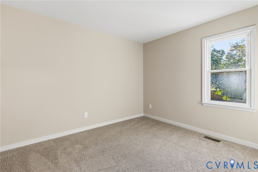 8736 Sunset Knoll Road Richmond, VA 23237 - Photo 12 of 26 an empty room with a window