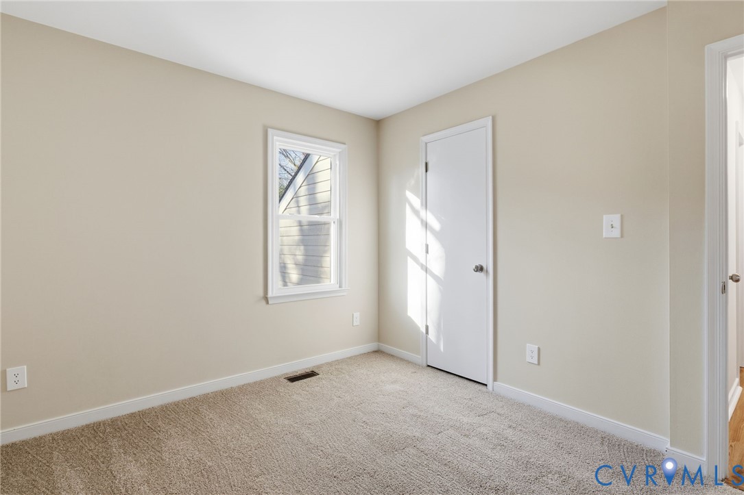 8736 Sunset Knoll Road Richmond, VA 23237 - Photo 13 of 26 an empty room with windows and closet