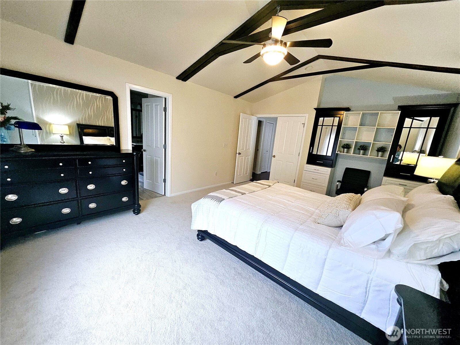 3259 Destination Avenue East Fife, WA 98424 - Photo 19 of 33 a bedroom with a bed a mirror on dresser and a flat screen tv