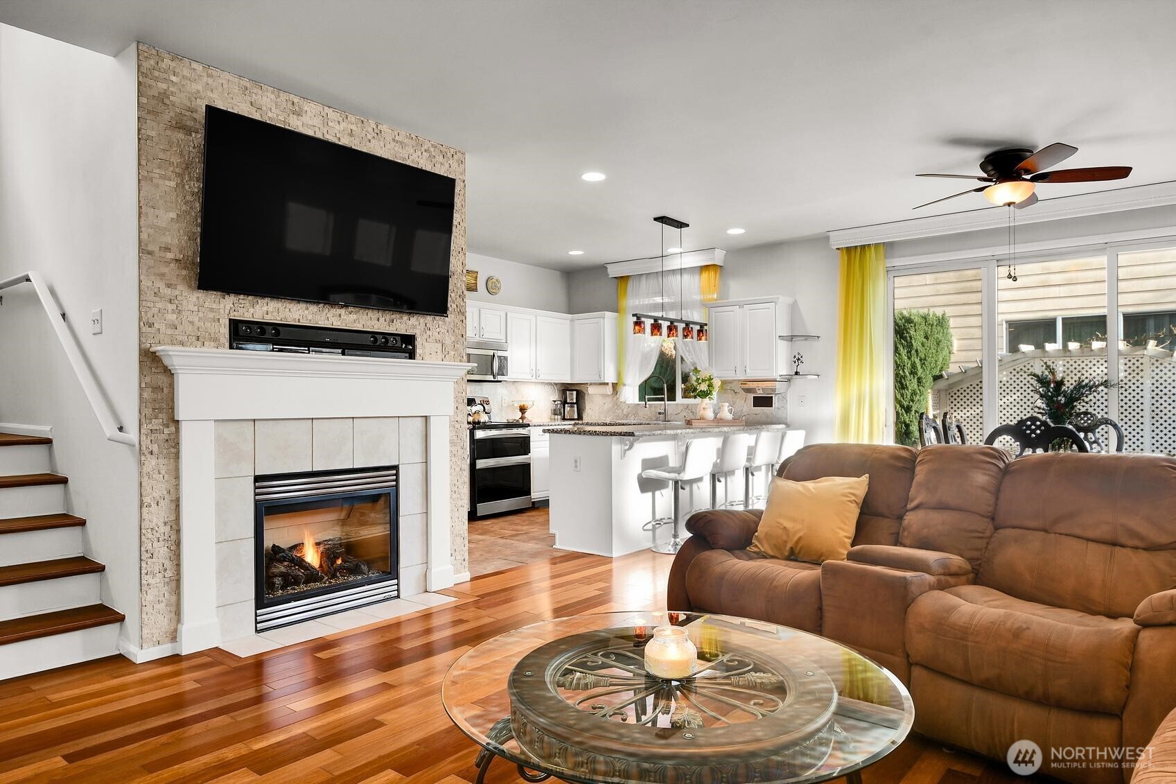 3259 Destination Avenue East Fife, WA 98424 - Photo 2 of 33 a living room with furniture a flat screen tv and a fireplace